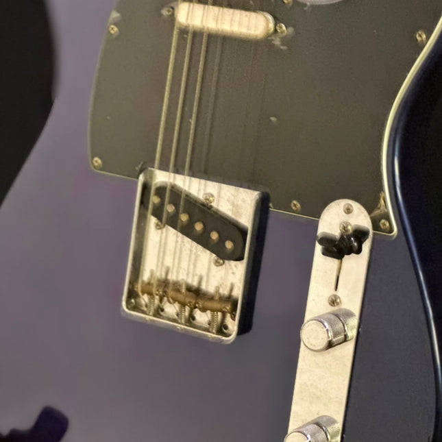 Azure metallic electric guitar with neck pickup, bridge pickup, and control hardware