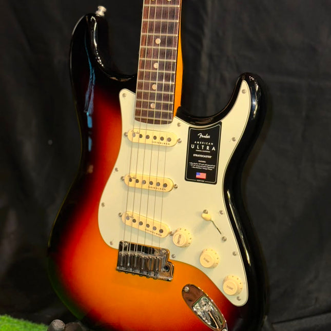 Electric guitar with sunburst body, white pickguard, and six-string bridge