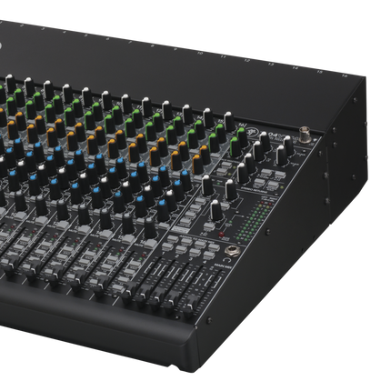 Close-up of analog mixer control surface with multiple knobs, faders, and labeled switches