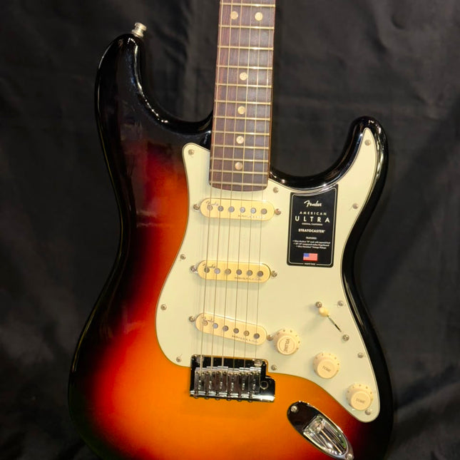 Electric guitar with sunburst finish, white pickguard, and twin pickups