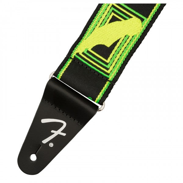 Neon monogram guitar strap close-up: neon green/yellow webbing with black end and buckle